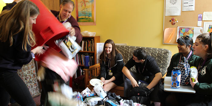 St. Joseph Worker Ceara Curry and Religion Teacher/Campus Minister Peter Gleich help students Allison Naber '20, Max Karas '20, Kate Dario '20, and Samantha Burrows '20 sort donations from the sock drive.