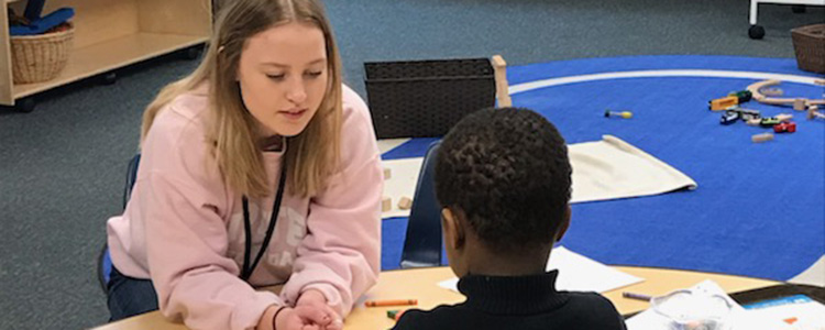 Lucy Johnson '19 enjoys helping the kids play and learn at Seward Montessori.