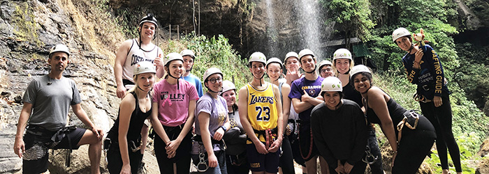 The CDH group is ready to rappel near a waterfall. After a strenuous hike and camp out at a cave, the group was ready for more adventure.