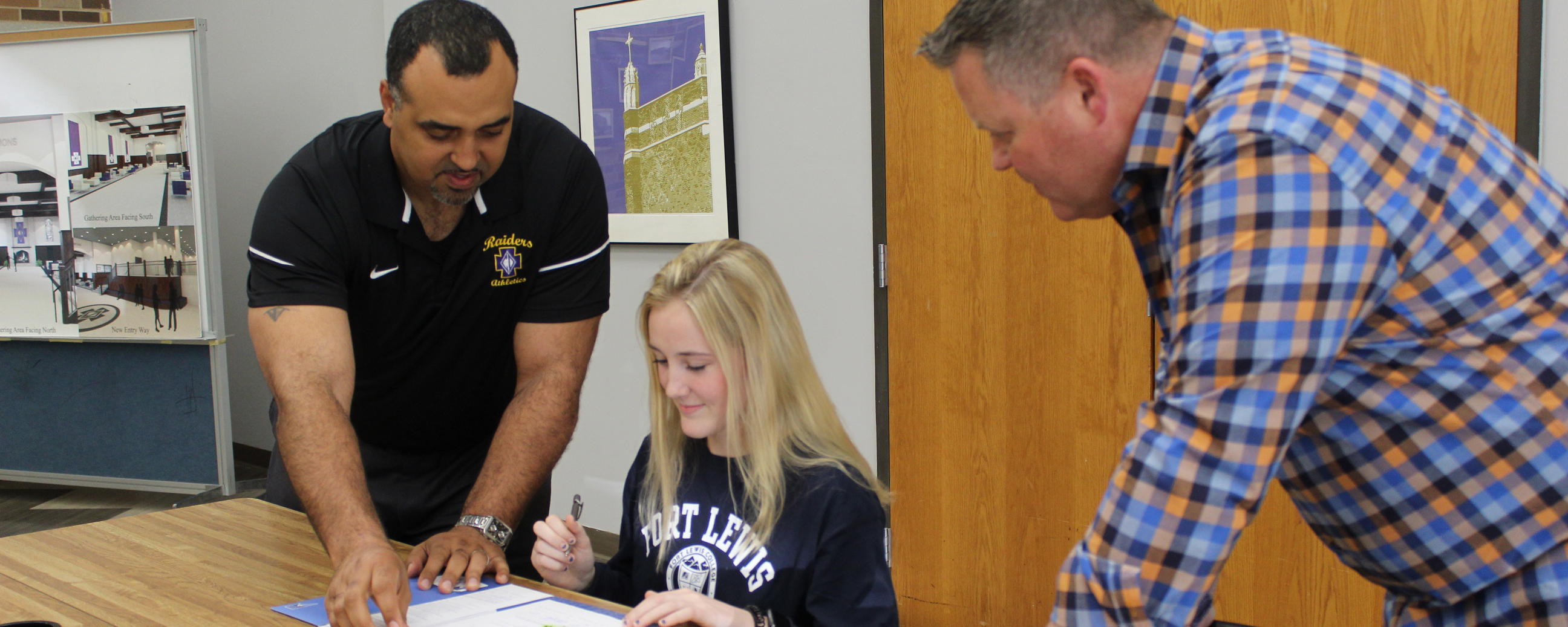 Olivia signs her contract with Athletic Director Phil Archer and her father looking on.
