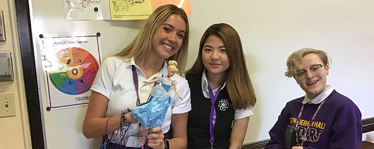 Samantha Salmen '19, Juwon Byun '19, and Sophia Schreier '19 test their calculations before Barbie goes bungee jumping.