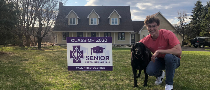 Corbin Graham '20 poses with his yard sign.