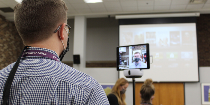 Choir Director Tyler Berg trains on use of the new Swivl device.