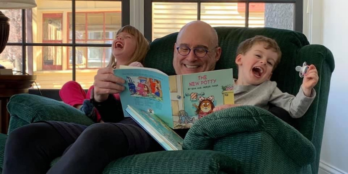 Michael Cole enjoys reading with his grandchildren.