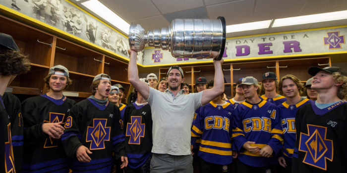 Ryan McDonagh '07 shows off the Stanley Cup to members of the boys hockey team.