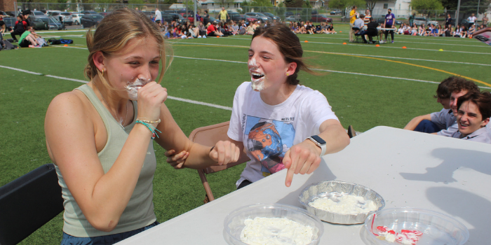 Students participate in the pie eating contest on behalf of their CASA houses