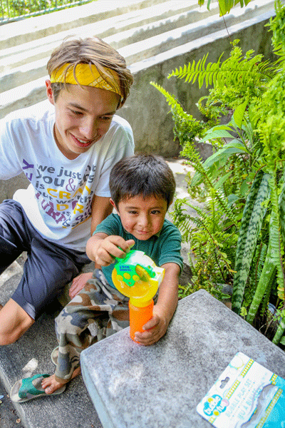 John Goodson'16 plays with child at the Women's Center in the mission at San Lucas Tolimán in Guatemala.