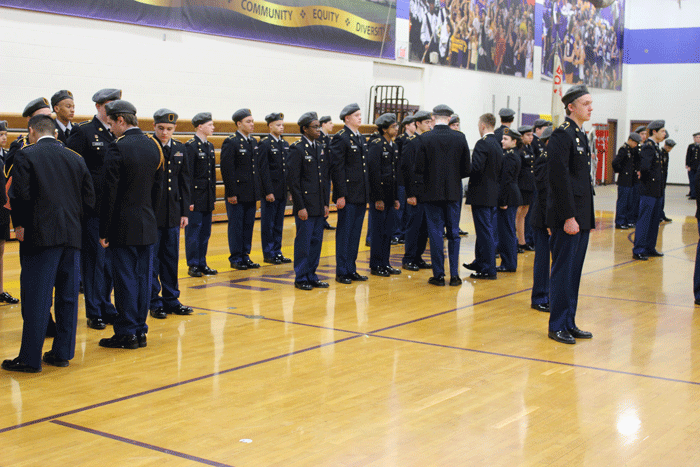 Evaluators inspect uniforms and ask knowledge questions as part of the In-Ranks Inspection portion of the Cadet Formal Inspection​.