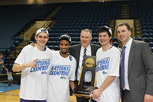 CDH Alumni and UST Teammates, Michael Hannon'14, Cortez Tillman'13, Taylor Montero'13 celebrate the 2016 NCAA DIII National Championship with Coach Tauer and Assistant Coach Mike Keating'02.