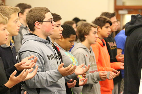 Ninth graders celebrate Mass during their retreat led by Fr. John Forliti'54.