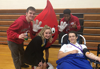 From L to R: Kevin Downes'18, Therese Mellum'18, Charlie Dennis'18, and Teddy Gray'18 with ABO Joe