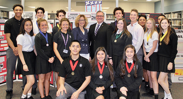 Students whose History Day projects qualified for the State competition are shown with President Frank Miley and Principal Mona Passman.