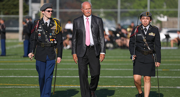 Reviewing officer Mr. John Schaller '71 accompanied by Cadet Colonel Leland Pornschloegl '18 and Cadet Lieutenant Colonel Giselle Centeno '18.