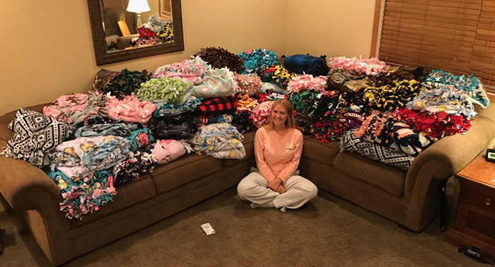 Mary Andrzejek surrounded by the 46 blankets she donated to Gillette's. 